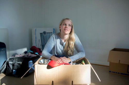 Young female with all her belongings in a box