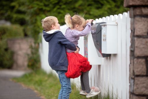 Children looking in the mailbox