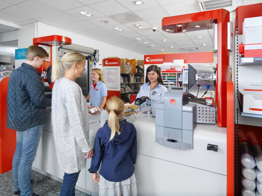 Post office indoor with two operators and customers in front