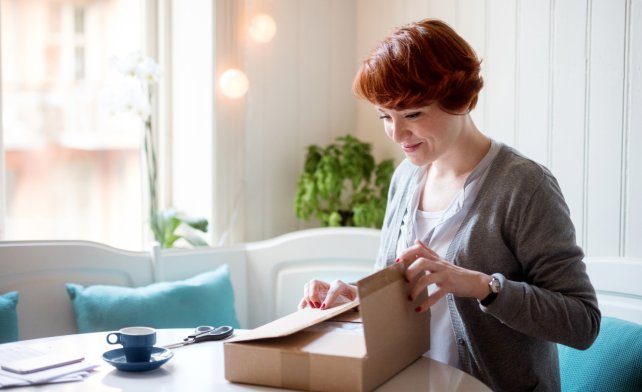 A woman packing a parcel