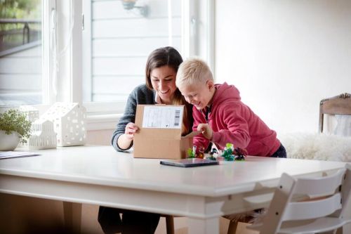 Mor og sønn titter forventningsfulle opp i en liten eske